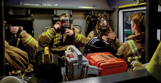 Firefighters putting on PPE