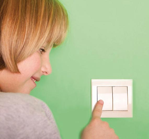 Girl turning off light switch