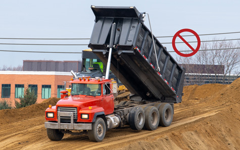 Dump truck operating near power ines