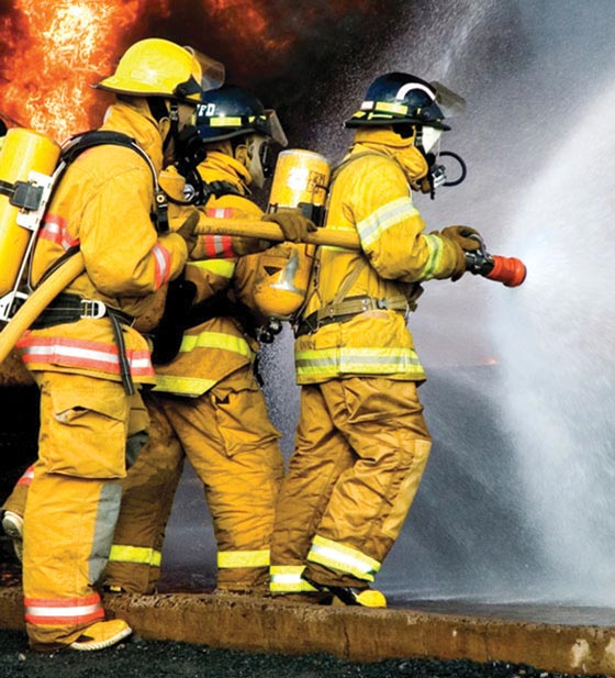 Firefighters using fog spray